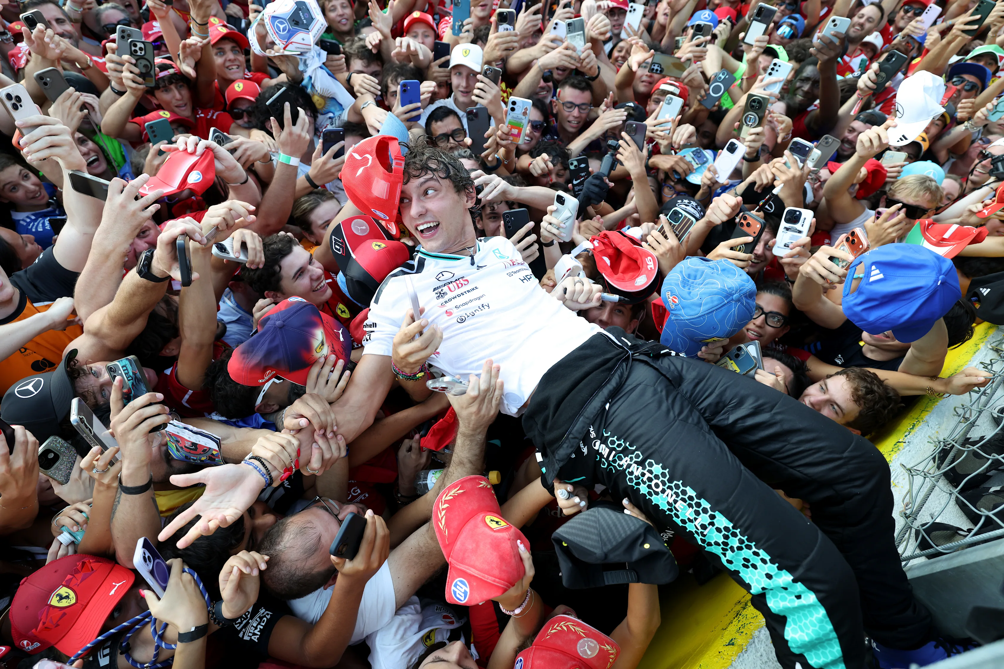 Kimi Antonelli celebrates with fans at Monza after his 2026 Italian Grand Prix win.